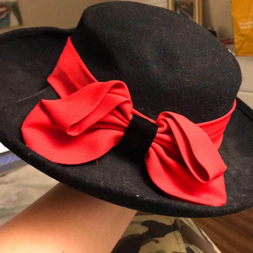 Old fashioned black hat with red ribbon